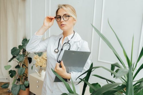 blond lekarka poprawiająca okulary